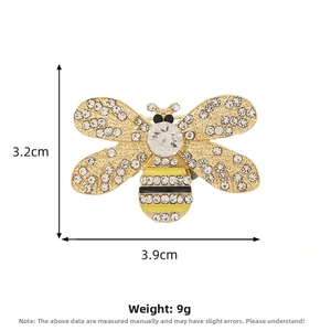 Detailed view of gold bee brooch with rhinestones and enamel, 3.2cm by 3.9cm size