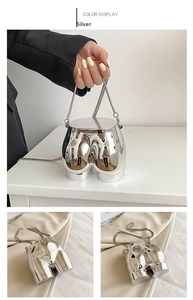Detailed view of silver mirror finish creative hip shaped handbag with metal chain strap