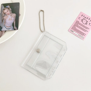 Macro view of transparent PVC 6-hole binder card holder with bead chain and snap button