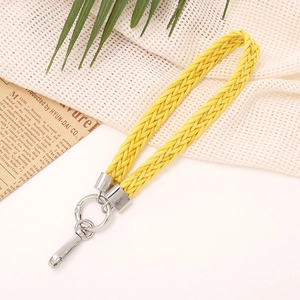 Close-up of bright yellow woven cotton wrist strap with polished silver metal clasp