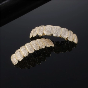 Gold plated hip hop grillz set featuring sparkling iced out micro paved cubic zirconia