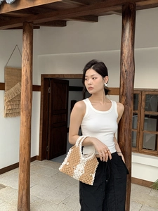 Detail view of handmade macrame woven tote bag in khaki and beige diamond pattern