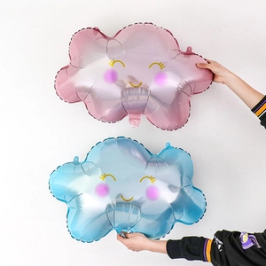 Detailed view of smiling rainbow cloud foil balloons in pink and blue for birthday decor