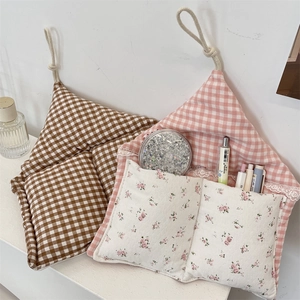 Close-up of wall hanging storage bags with plaid patterns and delicate lace edge