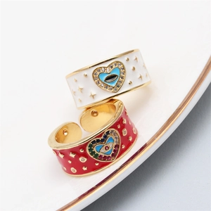 Adjustable evil eye rings with colorful zircon in red and white enamel on a ceramic tray