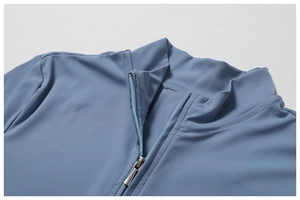 Detail of high collar zipper and stitching on blue yoga bodysuit short sleeve