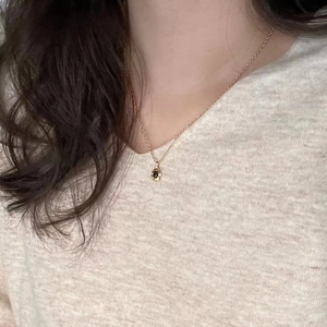 Minimalist 925 sterling silver necklace with round black gemstone pendant on a gold chain