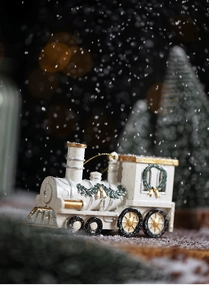 Detail of cream white Christmas train ornament with gold accents and glitter snowfall