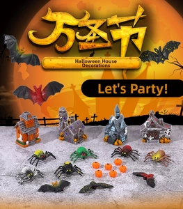 Detail of miniature Halloween resin houses, bats, spiders and pumpkins on orange background