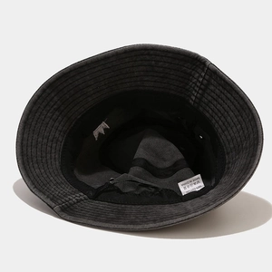 Detailed interior of a vintage grey bucket hat with cotton label and crown embroidery