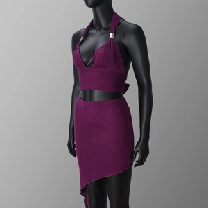 Detail of the high-stretch pleated fabric texture on a deep purple halter neck set