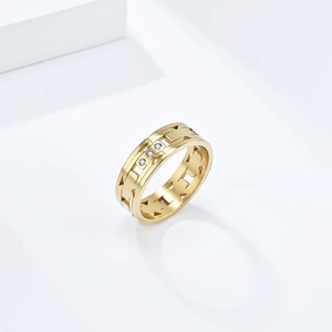 Modern gold titanium steel ring with H-link design and small diamonds on a white pedestal