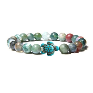 Detailed shot of elastic stone bead bracelet featuring a vibrant blue turtle charm decoration