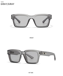 Macro detail of matte gray rectangular sunglasses with metal cross accents on temples
