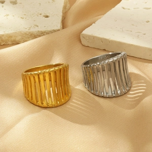 Detailed view of hollow vertical striped rings in gold and silver on champagne velvet