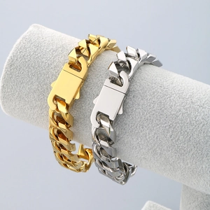Close-up of 13mm gold and silver Cuban link bracelets on a professional grey display