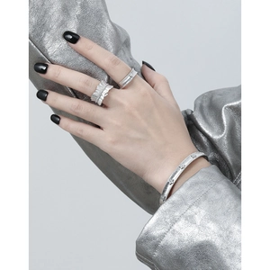 Matte silver jewelry set featuring two textured rings and a starry diamond bracelet