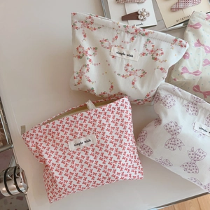 Flat lay of pink bow and floral cotton makeup bags with simple wish woven labels