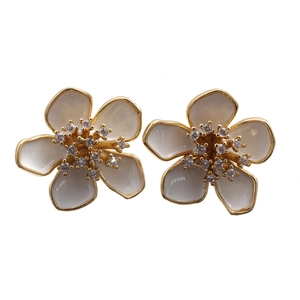 Elegant gold flower stud earrings with white enamel petals and sparkling cubic zirconia stones