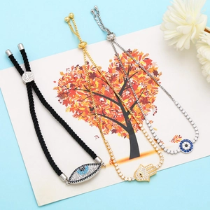 Detailed view of Evil Eye and Hamsa bracelets with sparkling zircon stones on art card