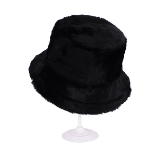Close-up of black faux fur bucket hat material showing thick plush texture and soft finish