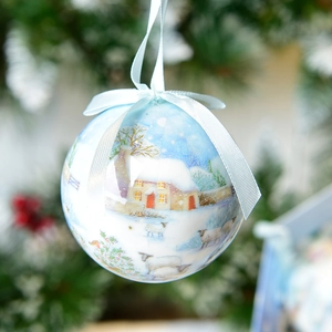 Close-up of 7cm light blue Christmas ball with snow scene pattern and silk ribbon