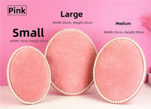 Three-piece pink velvet jewelry display boards with pearl trim in small, medium, and large sizes