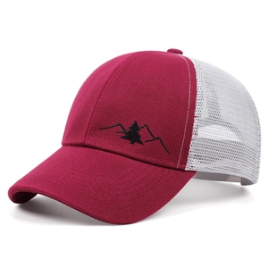 Detail view of red mountain embroidery and white mesh on breathable trucker baseball cap