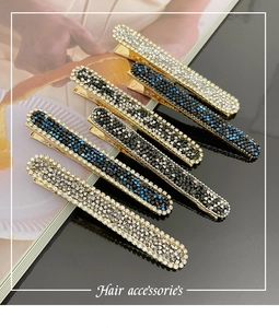 Detail view of sparkling rhinestone long hair clips in silver, blue, and black colors