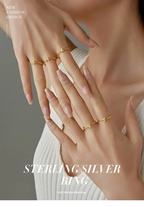 Detailed view of gold plated S925 sterling silver rings with pave H-shaped crystal accents