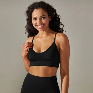 Detail of black seamless knit yoga bra with wide ribbed hem and thin shoulder straps