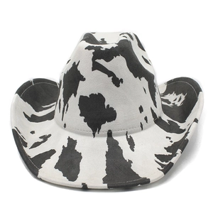Detailed front view of a western cow print cowboy hat with a curved brim and wide shape