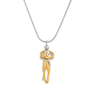 Detailed close-up of a two-tone embrace pendant on a silver snake chain necklace