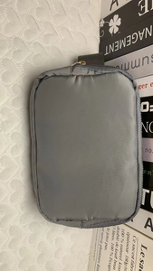 Close-up of waterproof dark gray nylon pouch with zipper and textured fabric detail