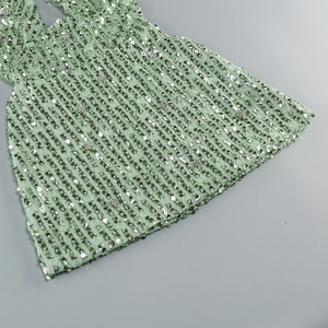 Detail of mint green sequins and floral rhinestone embellishments on a mini dress