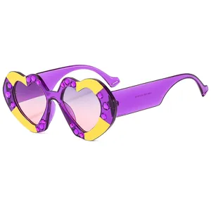 Trendy heart-shaped sunglasses with purple rhinestones and yellow accents for women