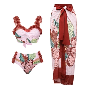 Detail view of 3-piece tropical bikini set with ruffled flowers and long red sarong