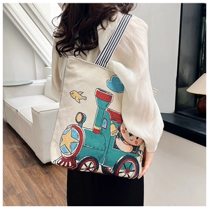 Canvas tote bag with cute cartoon bear print and black striped straps on shoulder