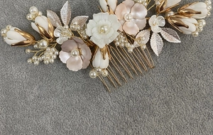 Detailed close-up of handmade bridal hair comb with ivory ceramic flowers and pearls