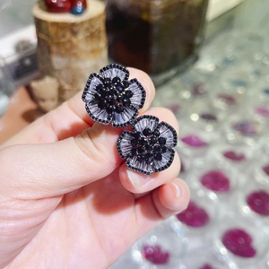 Exquisite camellia flower stud earrings with black and white cubic zirconia crystals