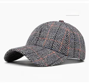 Detail of light gray plaid baseball cap with textured tweed fabric and curved brim