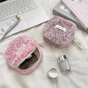 Detail of pink leopard plush pouch showing inner storage for cosmetics and makeup