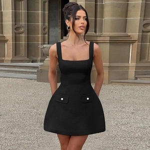 Close-up of black tweed dress with square neck and pearl button pocket detail