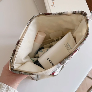 Interior view of floral embroidered pouch showing spacious capacity and canvas lining