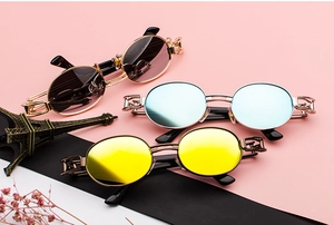 Steampunk sunglasses with retro hollow frames in multiple colors on a vintage display
