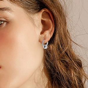 Minimalist silver stainless steel hoop earrings with crystal circle pendant on model