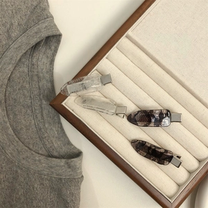 Set of four lace pattern hair clips neatly arranged in a wooden jewelry box