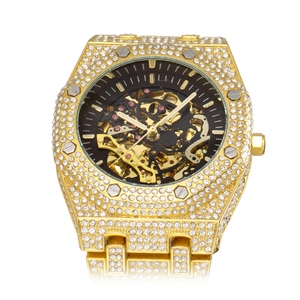 Luxury gold skeleton mechanical watch with full diamond setting for men in white background