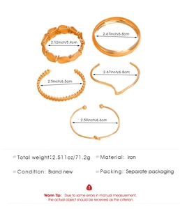 Detail view of five-piece gold multilayer geometric bracelet set with size specifications