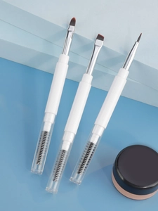 Detailed view of dual-ended makeup brushes with spiral brow brush and angled eyeliner tips